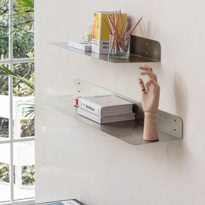 Maximize your wall space with these wall-mounted metal shelves. These metal shelves are made of 1.5 mm thick steel with a powder coating finish. These shelves have rounded corners for aesthetic, elegant look, and safety. These metal shelves are available in two sizes 24 inches and 36 inches in length, as well as a set. Powder coated in four beautiful colours: antique brass, textured black, brushed nickel, and white colours. Wall brackets are also provided to support more weight if needed. In mos Shelves In Living Room, Silver Shelf, Wall Corner Shelf, Bedroom Shelf, Accent Shelf, Metal Floating Shelves, Aluminum Shelves, Wall Shelves Bedroom, Bracket Shelf