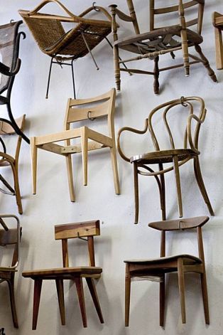 Chairs made by Josh Duthie hang on the wall at Woodshop in San Francisco, Calif., on Monday, December 20, 2010. Photo: Laura Morton, Special To The Chronicle Chair On Wall, Hang Chairs On Wall, Hanging Chairs On Wall, Chair Wall Ideas, Chairs On Wall, Chairs On Wall Display, Chair Display Ideas, Chair Display, Chair Display Showroom