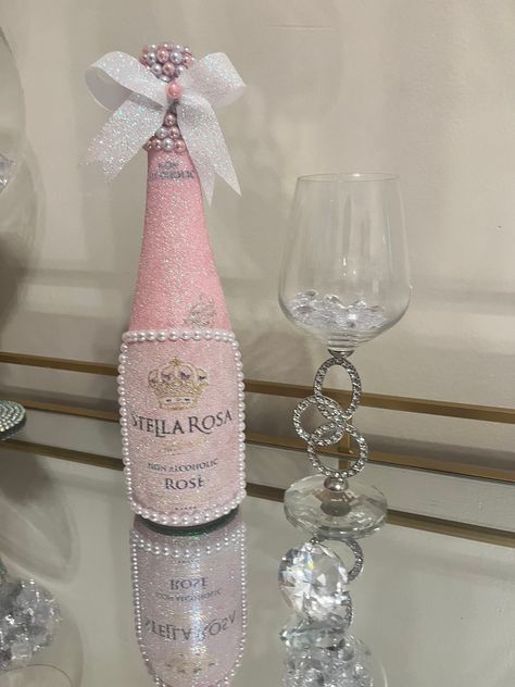 Beautiful hand decorated bottle with sparkling iridescent pink glitter.  Pearl gem border. Stunning pearl detail on the neck. This bottle is sold empty and the gemstone cap is sealed shut. This glam bottle is the perfect addition to your room, a gift, or table centerpiece for your special occasion. Please contact me if a larger quantity is needed, or with any other questions.  Perfect to use for:  - home decor - bar/restaurant decor - birthday parties - weddings - special occasions Decorated Champagne Bottles Quinceanera, Pink Glam Party Ideas, Wine Bottle Crafts Birthday, Badazzel Bottle, Pink Glitter Bottle, Paper Mache Wine Bottles, Fancy Wine Bottles, Don Julio Bottle Decorated Pink, Bottle Centerpieces Birthday