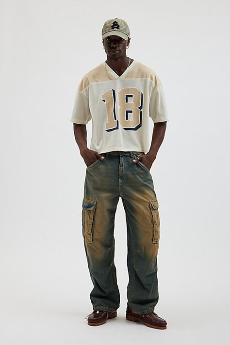 Mesh football jersey by Urban Outfitters. Semi sheer short sleeve t-shirt with a number graphic at the front. Boxy fit tee in a cropped length. Features UO football jersey Mesh football jersey tee Two-tone V-neck Number graphic Short sleeve Cropped length Content + Care 100% Polyester Machine wash Imported Size + Fit Model in Neutral is 6’2.5" and wearing size Medium Measurements taken from size Medium Chest: 46" Length: 23.5" | Urban Outfitters UO Mesh Football Jersey Tee in Neutral, Men's at U 90s Outfits For Men, Football Jersey Streetwear, Mesh Jersey Outfit Men, Alt Men’s Fashion, Nfl Jersey Outfit Men, Mens Cropped Shirt, Men’s Summer Streetwear Style, Cropped Shirt Outfit Men, Cropped Jersey Outfit