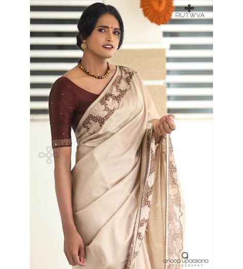 #Repost
///@rutwva_insta: M.A.P.L.E 🍁
.
Simple beige brown saree with cutwork detail on borders.

These cutworked borders are highlighted with handembroidery in cutbeads and beads.

This look is completed by pairing it with a burnt coffee pure rawsilk blouse with handembroidered sleeves.
.
Drop a message or contact on 9207675346/8848874044 for orders and enquiries.

Muse : @gourry_bhadhraas 
Photography : @anoopupaasana_photography 
MUA : @parinayah @rabisruthy 
Outfit&styling : @rutwva_insta Cream Colour Saree Blouse Combination, Coffee Brown Blouse Designs, Brown Saree With Contrast Blouse, Beige Saree With Contrast Blouse, Brown Saree Combination Blouse, Brown Blouse Designs For Saree, Coffee Brown Saree Combination Blouse, Coffee Brown Saree, Blouse Designing