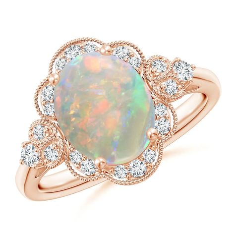 Drawing inspiration from the Victorian era, this ring holds at its heart a mysterious oval opal that tantalizes with its play of colors. Radiant diamonds form a glistening halo around the opal. Diamond studded twin leaf motifs and diamond accents adorn the shoulders of this 14k rose gold vintage opal ring. Vintage Opal Ring, Opal Ring Vintage, Victorian Engagement Rings, Alternative Wedding Rings, Diamond Halo Engagement Ring, Wedding Rings Halo, Tiffany Jewelry, Rose Gold Engagement, Halo Engagement Rings