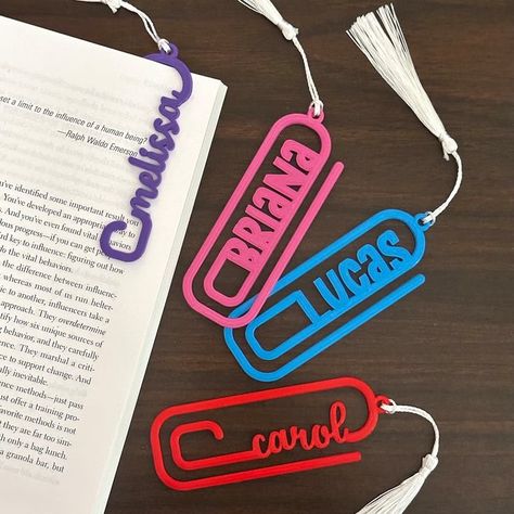 Our custom designed name bookmarks/page holders make unique gifts for every book lover you know! With its fun paper clip design, the bookmark can be used like a paper clip to mark your page in the book, or as a traditional tasseled page holder. Bookmarks are 3D printed on PLA/ABS plastic and come in various colors with your choice of block or script text for the name. They measure approx 4.5in x 1.5in with a thickness of 2mm. Please note: For Script Text design, ALL letters will be in small Name Bookmarks, Paper Clip Bookmark, Clip Bookmark, Drukarka 3d, Page Holder, 3d Printing Business, Acrylic Ideas, Plastic Recycling, 3d Printing Art