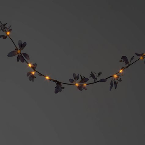 Welcome friends and family to your haunted home with these 25 LED Faux Leaves Garland Halloween String Lights from Hyde & EEK! Boutique™. These Halloween string lights features a black leaves garland that's wrapped with 25 LED bulbs to cast a creepy-festive glow. Simply drape on your front door, balcony, patio or even on the fireplace mantel or stairway to decorate your space for trick-or-treaters. Hyde & EEK! Boutique™: Thrilling delights. Curious oddities. Modern Goth Decor, Halloween Staircase Decor, Outside Halloween Decorations, Glow Halloween, Leaves Garland, Halloween String Lights, Garland Halloween, Halloween Front Doors, Halloween Decor Ideas