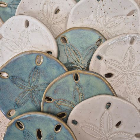 The ocean's curren-sea! I feel extra happy today. These sand dollar shell coasters came out exactly 💯 beachy! Bring some seaside happiness into your life. Blue ocean water, white sandy beaches, sunny warm coastal days 🌴🐚☀️ #sand #sea #shells #seashells #sanddollar #ceramics #coastalliving #sunshine #seaside #home #beachvibes Coastal Ceramics, Sanddollar Crafts Diy Ideas, Pottery With Shells, Ocean Pottery Ideas, Air Dry Clay Beach Theme, Air Dry Clay Shell Dish, Clay Sand Dollar, Clay Coasters, Ceramic Sand Dollar