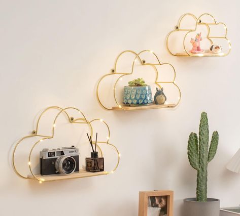 PRICES MAY VARY. Golden Cloud Shape Floating Shelf is Made of Wood Base and Metal Bracket. Set of 3 Floating Shelf. The Size:Large (14.2 x 9 x 4 inches), Medium (11.8 x 8 x 4 inches), Small (9 x 6 x 4 inches). Make Great Use of The Empty Place and Create a Warm style Space Place to Display Your Photo，Collectibles and Organizes and More. An good Ideal Wall Decoration for Your Home. Living Room, Apartment, Dorm Room, Bedroom, Dining Room or Office. Super Easy Installation. Simply Insert The Given Floating Shelves With Led Lights, Shelves With Led Lights, Led Lights Wall, Lights Wall Decor, Cloud Shelves, Shelf Decorations, Wall Mounted Shelf, College Dorm Desk, Dorm Room Storage