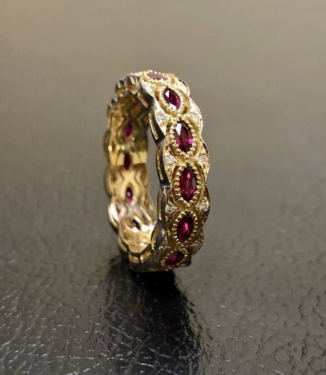 DeKara Designs Collection Metal- 18K Yellow Gold, .750. Stones- 12-15 Genuine Marquise Rubies 1.50-1.90 Carats, 28-34 Round Diamonds F-G Color VS1 Clarity 0.15-19 Carats. Entirely Handmade 18K Yellow Gold Eternity Diamond Marquise Ruby Engagement Band. This band is extremely elegant featuring beautiful red marquise shaped rubies that are all professionally burnish set individually with amazing bead work surrounding each stone. There are 28 professionally pave set round diamonds on the top and bo Different Diamond Colors, Vintage Ruby Gold Rings, Intricate Ruby Wedding Ring, Gold Ruby Rings With Intricate Design, Ornate Gold Ring With Ruby, Diamond Wedding Band, Wedding Ruby Ring In Yellow Gold, Fine Jewelry Style, Ruby Ring Designs, Ruby Eternity Band