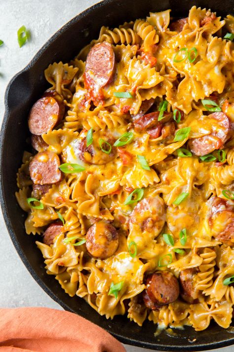 One Pan Cheesy Smoked Sausage Pasta recipe has smoked sausage and pasta in a spicy, creamy sauce that's all cooked in one pan for a quick weeknight meal. Cheesy Sausage Skillet, One Pan Cheesy Smoked Sausage And Pasta, Cheesy Pasta And Sausage, Pasta With Turkey Sausage, Dinner Ideas Using Smoked Sausage, Spicy Pasta With Sausage, One Pot Cheesy Smoked Sausage Pasta, Cheesy Smoked Sausage Skillet, One Pot Kielbasa Recipes