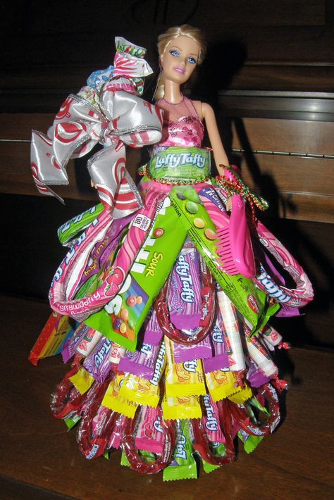 Barbie in a candy dress. Make a cardboard cone for around her waist. I began at the bottom & taped candy around in layers. Candy Barbie Dress, Barbie Candy Dress, Candy Tree For Birthday, Barbie Doll Candy Bouquet, Birthday Cake Made Out Of Candy, Barbie Doll Money Dress, Candy Boquets, Candy Boquets Dollar Tree, Candy Boutique