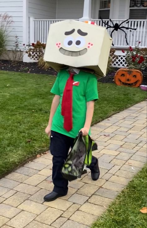 An individual wearing a green t-shirt with a white collar, red tie, red rectangular pin with a diagonal white stripe (top right to bottom left), black pants, black shoes, and a origami-rock-shaped head with an orange striped red and white hat who is walking nervously while holding a trick-or-treat bag Among Us Costume Ideas, Darwin Watterson Cosplay, Gumball And Darwin Halloween Costume, Amazing World Of Gumball Cosplay, Cartoon Network Halloween Costumes, Larry Amazing World Of Gumball, Gumball Halloween Costume, Gumball And Darwin Cosplay, Tawog Cosplay