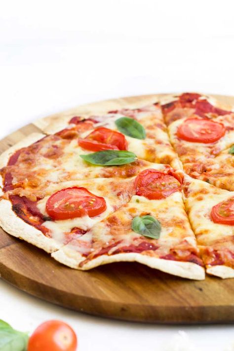 Looking for a quick, easy and tasty lunch option? Tortilla Pizzas is something the whole family will love. Top a tortilla wrap with pizza sauce, cheese and your favourite pizza topping. Bake in the oven until the cheese is golden and bubbly and the base is crispy. A fun lunch to make with kids - set up a toppings bar (tons of suggestions given in post) and let them get creative.. #tortillapizza #homemadepizza #lunchidea #kidsfood #kidslunch #kidsinthekitchen Tortilla Pizzas, Pizza Wrap, Pizza Tortilla, Resep Pizza, Toppings Bar, Pizza Wraps, Meat Lovers Pizza, Low Carb Soup Recipes, Healthy Pizza Recipes