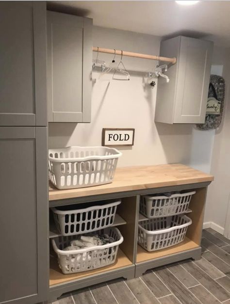 We used two matching bathroom vanities(minus the wash basin top) from Home Depot and just removed the doors for the laundry basket storage and added a butcher block counter top. Laundry Room Update, Laundy Room, Laundry Room/mud Room, Laundry Room Wallpaper, Wash Room, Dream Laundry Room, Basement Laundry, Mudroom Laundry Room, Laundry Room Layouts