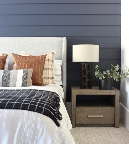 A tailored bedroom design with hale navy blue shiplap wall, cozy plaids, wool and stripes layer the bed and chic leather for a cozy contemporary vibe. Navy Blue Shiplap Wall, Blue Shiplap Wall, Blue Shiplap, The Forest Modern, Tan Bedroom, House Of Silver Lining, The House Of Silver Lining, Boy Bedrooms, Navy Bedrooms