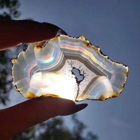 This beautiful Rainbow Iris Agate Slice is available at Simply Affinity. These rainbow agate slices are incredibly rare and found in Indonesia. They look like a regular slice of agate until viewed through transmitted light, and then an incredible spectrum of colors appears. There are said to be a very small percentage of iris agates in the world. #SimplyAffinity #Crystals #Gemstones #IrisAgate #Metaphysical #Agate #RainbowAgate #MetaphysicalProperties Iris Agate, Manipura Chakra, Minerals Crystals Rocks, Crystal Vibes, Crystal Aesthetic, Pretty Rocks, Cool Rocks, Agate Slice, Minerals And Gemstones