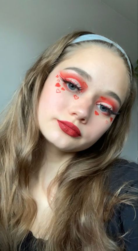 Red eyeshadow 
Red lipstick 
Red makeup
Valentines days makeup
Red hearts
Heart makeup
Fake Eyelashes 
Blush
Glowy makeup 
Vday makeup
Cut crease eyeshadow 
Red Eyeliner 
Winged eyeliner