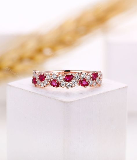 *Design inspiration* Cluster rings often receive plenty of attention. Featuring smaller diamonds placed next to each other, they can be designed to form various shapes that come up to your mind. And the smaller stones compliment each other and offer extra sparkle. This collection makes themselves a popular choice for those seeking u unique design. Ring Information Item: Natural Ruby Wedding Band Metal: 14k/18k solid gold, Platinum 950 Wedding Band ▲Center Stone:Natural Ruby Shape: Pear Shaped  S Fine Jewelry Cubic Zirconia Ruby Ring For Wedding, Elegant Ruby And Diamond Half Eternity Ring, Fine Jewelry Diamond Ruby Half Eternity Ring, Wedding Ruby Ring With Diamond Cut Cubic Zirconia, Wedding Ruby Ring With Halo Design And Cubic Zirconia, Dazzling Ruby Ring With Diamond For Anniversary, Ruby Ring With Cubic Zirconia Halo Design For Wedding, Elegant Half Eternity Rings With Lab-created Ruby, Ruby Wedding Ring With Diamond Accents