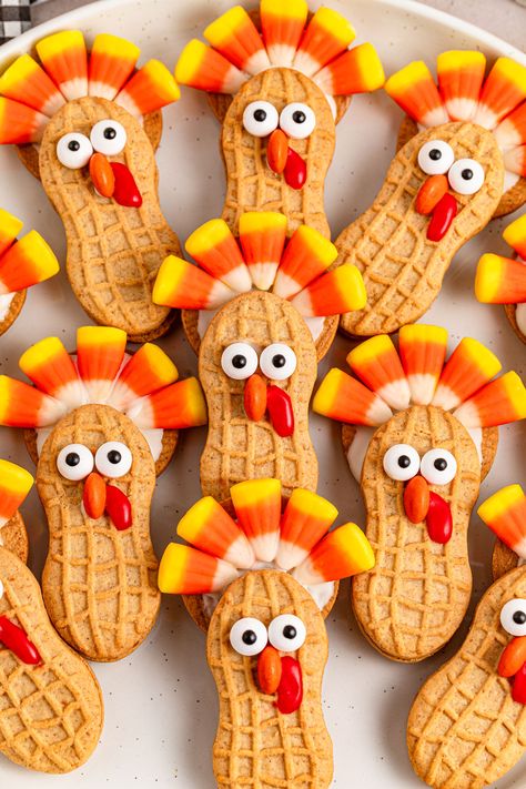 Nutter Butter Turkeys are a fun and festive no-bake treat that's perfect for Thanksgiving celebrations. These adorable cookie creations use classic Nutter Butter cookies, candy corn, and chocolate to make cute turkey shapes that kids and adults alike will love. Ideal for holiday parties, classroom treats, or a fun kitchen project with the family, these easy-to-make Nutter Butter Turkeys add a playful touch to your dessert spread. Enjoy the sweet and whimsical charm of these turkey-themed treats that bring the holiday spirit to life! Butter Turkey, Peanut Butter Sandwich Cookies, Candy Wafers, Thanksgiving Desserts Table, Turkey Treats, Turkey Cookies, Candy Eyeballs, Cookies From Scratch, Nutter Butter Cookies