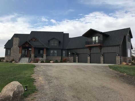 iron ore exterior modern farmhouse Dark House With Stone Exterior, Iron Ore Farmhouse Exterior, Black Country House Exterior, Dark House Exterior Single Story, Black Barndominium Exterior With Stone, Dark Modern Farmhouse Exterior Colors, Black And Grey Barndominium, Black One Story House, Moody Home Exterior Colors