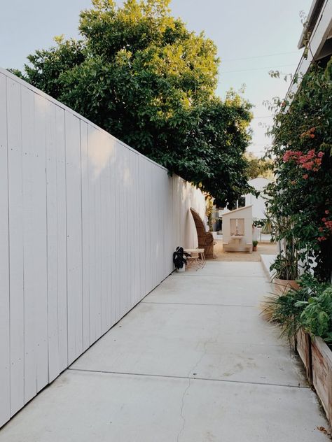 updating our old fence on a budget - almost makes perfect Paint Old Fence, White Painted Fences Ideas Backyards, White House White Fence, White Painted Fence, Painted Backyard Fence, Fencing On A Budget, White Fence Paint, Painted Wooden Fence, Paint Fence Ideas Backyards