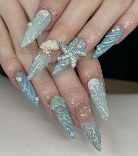 Dive into an ocean of elegance with our Ocean Fantasy Press On Nails Set! This stunning collection features hand-painted 3D designs inspired by the beauty of the sea, including starfish, shells, and ocean waves. Each nail is adorned with iridescent details that capture the shimmering magic of the underwater world, making these nails perfect for beach lovers and mermaid enthusiasts. 🐚💙  Set Includes: 10 hand-painted press on nails with unique 3D sea creature designs and iridescent accents.  Designs: 3D Starfish & Shell Charm: A captivating design featuring a 3D starfish and shell charm, set against a translucent blue base. The realistic textures and iridescent details make this design perfect for ocean lovers. 🐚⭐ Ocean Wave Patterns: Intricate wave designs flowing across a pale blue base Nails Nautical, Nails Mermaid, Fake Acrylic Nails, Sea Nails, Jellyfish Design, Mermaid Vibes, Fantasy Nails, Mermaid Nails, Sea Inspired