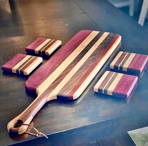 "This multi wood charcuterie board will for sure turn heads when it is brought out covered in your favorite tastes. The Maple and Walnut is a very classic combination which the purple heart accents very well. The dimensions of this board are 21\" Overall length, 6.5\" W, the handle is 4.5in in length. This is not only functional but is also something to talk about and display in your kitchen, dining room, or whomever you like to host. Since these boards are made to order it should take about 4 d Handmade Charcuterie Board, Wood Charcuterie Board Design, Charcuterie Board Woodworking, Charcuterie Board Purple, Charcuterie Board Wood, Wooden Charcuterie Board, Charcuterie Board Diy, Wood Charcuterie Board, Purple Heart Wood