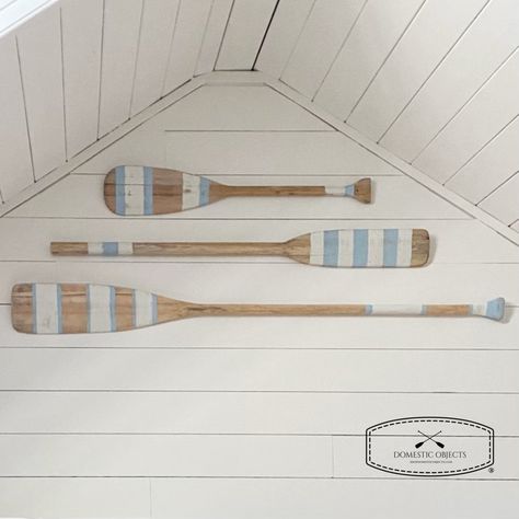 "Elevate your home decor with our beautifully handmade painted paddle wall art, a true testament to the timeless allure of coastal living. Inspired by the rustic beauty of the ocean, this hand-painted masterpiece brings a touch of seaside serenity right into your living space.  SIZES Small 35.25\" (89.5cm) length X up to 5.75\" (14.5cm) wide Medium 48\" (122cm) length X up to 5.75\" (14.5cm) wide Large 54\" (137cm) length X up to 5.75\" (14.5cm) wide STYLE  Choose from paint style  #1,#2 or #3 OUTDOOR/INDOOR These are made with the intention of being used for indoor wall decor, do don't expose to elements.  COLOR Natural unfinished wood with ivory and light coastal blue paint. Intentionally distressed/antique finish. HANGING OPTIONS Does not come with hardware as everyones wall situation a Beach House Color Palette, Coastal Blue Paint, Oar Decor, Painted Paddles, Beach House Colors, Lake House Interior, Lake Retreat, Beach House Wall Art, House Wall Art