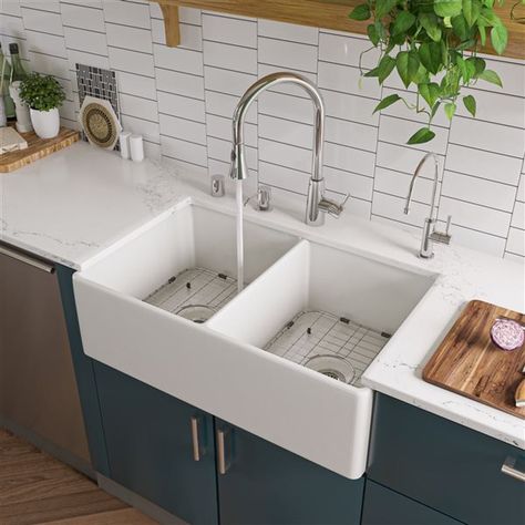 This ALFI Brand apron front/farmhouse fireclay kitchen sink is designed to complement your cooking space and make it even more functional. With its large double equal bowl this white sink will help you in all your tasks in the kitchen and will facilitate the cleaning of the dishes. The modern design and smooth surfaces create a flawless look for years to come. It measures 32.75-in (L) x 19.88-in (W) and comes with 1-year limited warranty.Bottom width: 32 1/2-in; Top width: 32 3/4-in3 1/2-in rear center drainWall thickness: 3/4-inNon reversibleBowl dimensions: 15 1/8-in x 18 1/8-in x 9 1/8-inDue to the organic nature of the fireclay material, dimensions may vary by 1/8-in of 1-inThis sink can be installed in 3 different ways: Undermount, topmount and flushmountThis sink is constructed of so Farm Sinks, Double Basin Kitchen Sink, Traditional Faucet, Single Hole Kitchen Faucet, Farmhouse Kitchen Sink, Apron Sink Kitchen, Apron Sink, Sink Grid, Farmhouse Aprons