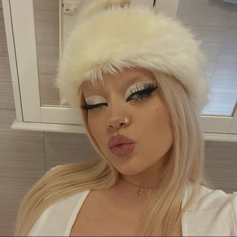 This is a photograph of a girl wearing glam makeup. She is wearing white and gray eyeshadow with a nude lipstick. White Bunny Makeup, White Eyebrows Makeup, Snow Bunny Makeup, Halloween Makeup Angel, Rave Eyeliner, White Makeup Ideas, White Makeup Looks, Winter Eyeshadow Looks, Eccentric Makeup