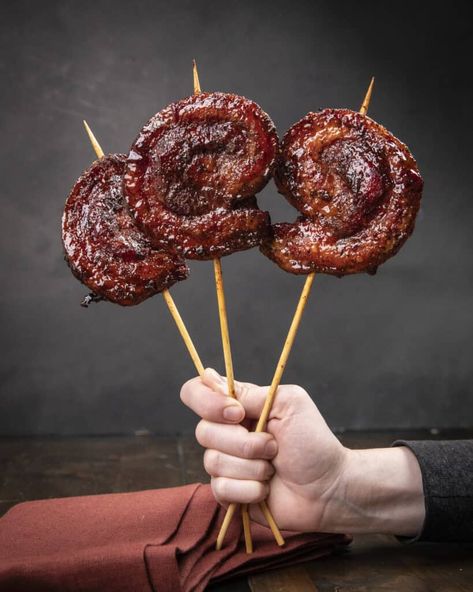 Meat candy on a stick! These smoked pork belly pinwheels with maple bourbon glaze are sweet, sticky, and down right delicious. Bbq Party Recipes, Smoked Pork Appetizer, Candy Pork Belly, Pork Belly Pinwheel, Pork Belly Kabobs, Porkbelly Dinner, Pork Belly Bacon Recipes, Smoked Pork Belly Pinwheels, Pork Belly Lollipops