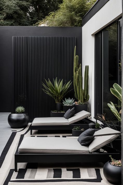 Embrace minimalism with this sleek outdoor lounge, featuring clean lines and a sophisticated black and white palette. Comfort meets style in the sun loungers, accented with textured cushions, set against a backdrop of striking desert plants. This space is a testament to modern design in harmony with nature. #MinimalistDesign #OutdoorLounge #DesertChic #ModernGarden #TexturedDecor #StylishOutdoors Textured Cushions, Black And White Palette, In Harmony With Nature, White Palette, Sun Loungers, Harmony With Nature, Patio Garden Design, Small Balcony Decor, Outdoor Gardens Design