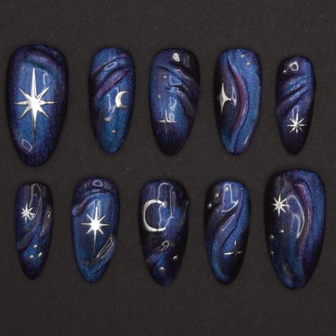 Set of 10 nails. Pictured: Almond M.  Dark and dreamy night sky gel press-on nails featuring stars, moons, a 3D gel design, and an enchanting color-shifting magnetic cat eye effect. Colors shift between yellow, pink, purple, blue and turquoise depending on the lighting and angles. Made to order nails, available in Extra Short, Short and Medium length in shapes Almond, Square, Round, Stiletto and Coffin.  This set is crafted with meticulous care using high-quality materials, including Après Natur Purple Sun And Moon Nails, Dark Nails With Stars, Cat Eye Nails With Stars, Purple Cat Eye Nail Designs, Gray Purple Nails Ideas, Cat Eye Press On Nails, Xiao Inspired Nails, Raven Nails Designs, Galaxy Gel Nails