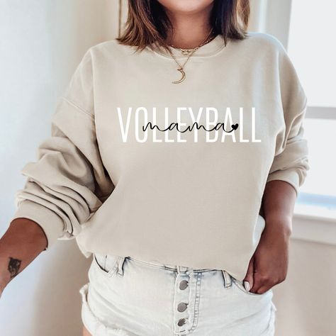 "The minimalist \"Volleyball Mama Sweatshirt\" is a sturdy and warm crewneck sweatshirt bound to keep you warm in the colder months. These cozy sweatshirts make a great gift for baseball lovers! A pre-shrunk, classic fit sweater that's made with air-jet spun yarn for a soft feel and reduced pilling. Sweatshirt details: * 50% cotton, 50% polyester * Pre-shrunk * Classic fit with no center crease * 1x1 athletic rib knit collar with spandex * Air-jet spun yarn with a soft feel and reduced pilling * Volleyball Sweatshirts, Custom Crewneck Sweatshirts, Baseball Sweatshirts, Volleyball Mom, Gildan Sweatshirt, Mama T Shirt, Nurse Sweatshirt, Softball Mom, Mama Sweatshirt