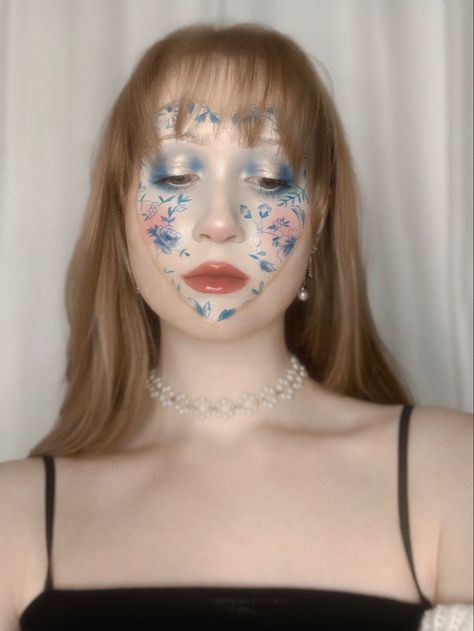 Porcelain makeup look, vase inspired makeup, face paint, blue face paint, gold face paint, face art, blue eyeshadow, gold eyeshadow, pretty makeup, fun makeup, intricate makeup, lip gloss, selfie inspiration, self portrait inspo, red hair, bangs Porcelain Skin Makeup, Porcelain Makeup, Red Hair Bangs, Gold Face Paint, Blue Face Paint, Paint Face, Heart Makeup, Makeup Lip Gloss, Porcelain Heart