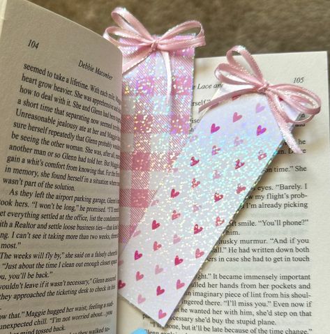 This handmade holographic bookmark is a perfect addition to any book lover's collection. With its cute pink heart or plaid coquette bow design, it is sure to make your reading experience even more enjoyable. Cute Design: The pink heart or plaid coquette bow bookmark adds a touch of cuteness to your books. *The design is printed on both sides of the bookmark* Handmade: Each bookmark is carefully crafted by hand, ensuring its uniqueness and quality. Laminated for extra protection! Holographic Effe How To Store Bookmarks, Pink Bookmark Ideas, Girly Bookmarks, Book Mark Design, Cute Bookmarks Handmade, Coquette Bookmark, Bow Bookmark, Book Mark Ideas, Cute Pink Heart