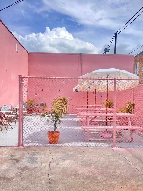 Pink patio with love locks and palm trees Cafe Pink Design, Cute Pink Cafe Interior, Pink Cafe Design Ideas, Pink Container Cafe, Pink Coffee Truck, Pink Cafe Design, Girly Backyard, Pink Cafe Interior, Pink Outdoor Furniture