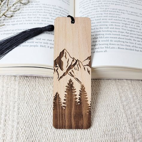 Add a touch of nature to your next novel with these beautiful eco-friendly wooden bookmarks. All bookmarks are engraved in-house using sustainably sourced American hardwood. After your new bookmark is engraved, it is finished with a black bookmark tassel. Best of all, this product is all-natural, so you can feel good about shopping small AND eco-friendly! Material: sustainable American hardwood, unfinished Sizing: 1.7 inch L x 5 inch W Thickness: 1/16 inch Diy Wooden Bookmark, Wood Burning Bookmark Ideas, Wooden Bookmark Ideas, Wood Burn Bookmarks, Wooden Bookmarks Diy, Small Wood Burning Ideas, Wood Burning Bookmarks, Wood Burned Bookmarks, Woodburned Bookmarks