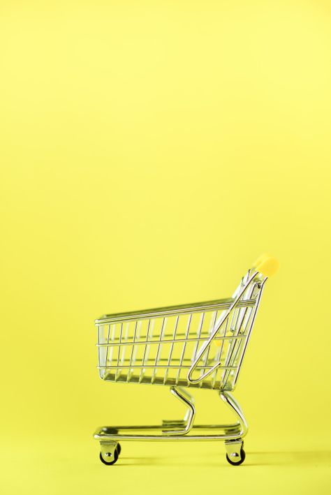 Shopping cart on yellow background. shop trolley at supermarket. sale, discount, shopaholism concept. consumer society trend Premium Photo | Free Photo Shopping Cart Logo, Cart Logo, Yellow Aesthetic Pastel, Minimal Photo, Shopping Trolley, Brand Kit, Yellow Aesthetic, Modern Branding, Photo Editing Software