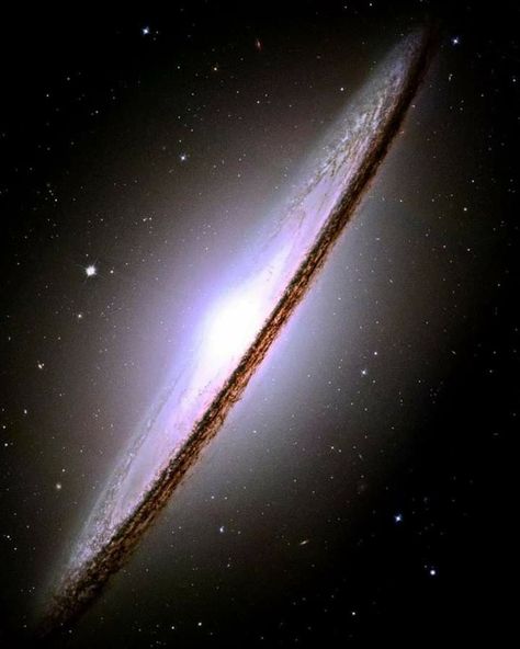 The Sombrero Galaxy Also known as Messier 104, M104 or NGC 4594is a lenticular galaxy in the constellation Virgo found 31,100,000 light-years from Earth. The galaxy has a diameter of approximately 50,000 light-years, 30% the size of the Milky Way. It has a bright nucleus, an unusually large central bulge, and a prominent dust lane in its inclined disk. The dark dust lane and the bulge give this galaxy the appearance of a sombrero hat. Sombrero Galaxy, Astronomy Facts, Galaxies Wallpaper, Star Map, Light Year, Space Pictures, Deep Space, Space And Astronomy, Print Ads