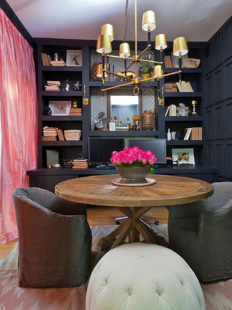 Home office features a wall of navy built-in shelves over a navy built-in desk facing a round trestle table lined with gray slipcovered chairs illuminates by a Jonathan Adler Ventana 2 Tier Chandelier atop a pink herringbone rug across from pink silk curtains. Reading Room Design, Piano Library, Glam Dining Room, New York Brownstone, Home Library Decor, Genevieve Gorder, Asian Homes, Library Decor, Home Libraries