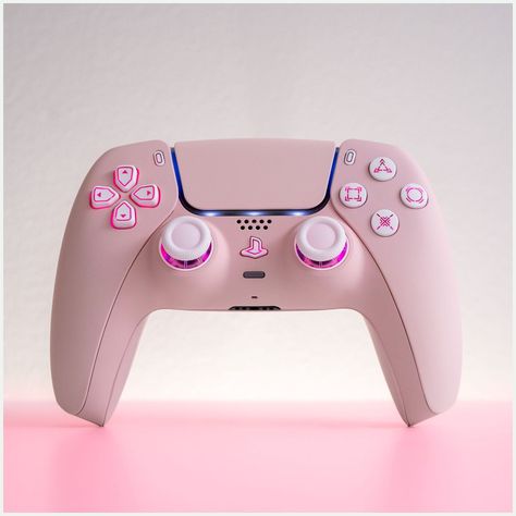 [AffiliateLink] Pink And Stunning, This Ps5 Controller Is Customized To Perfection. Fitted With A Light Sakura Pink Shell, It Boasts An Led Mod That Illuminates Its White Buttons And Analogue Sticks, Making It A Showstopper In Your Hands And A Stunning Piece Of Gaming Hardware As It Rests Next To Your Ps5. Your Gaming Setup Will Never Be The Same.When A Gaming Controller Is Engineered Pretty Much To Perfection Like The Ps5, You Really Wonder What Is Left For Us #pinkgamingsetup Pink Ps5, Pink Games, Gamer Setup, Ps5 Controller, Gamer Room Decor, Gaming Controller, Gaming Room Setup, Gamer Room, Pc Setup