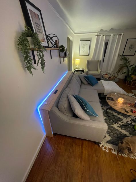 Oak board Couch console with speed charger outlet and LED smart light. Behind The Couch Lighting, Behind Sofa Shelf, Light Behind Couch, Fairy Lights Behind Couch, Behind Couch Shelf, Led Light Behind Sofa, Table Decor Behind Couch, Behind Couch Console Table, Shelf Behind Sofa