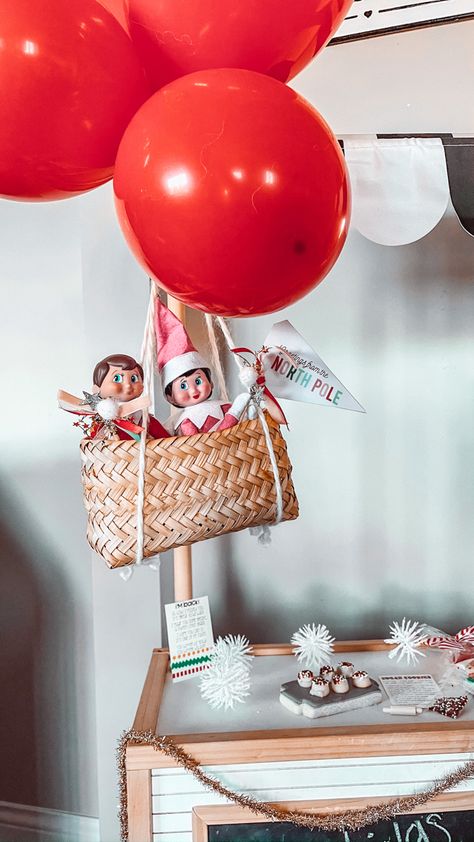 Hot air balloon your elf in from the north pole! Balloons Elf On The Shelf, Elf In A Box Ideas, Elf On The Shelf Hot Air Ballon, Elf Shopping Cart, Elf Parade Ideas, Elf Parachute Diy, Elf I’m Back Balloon, Paper Airplane Elf On Shelf, Elf On Shelf Photo Shoot