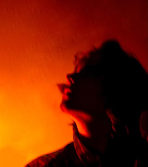 Woman with dark shadows and red, yellow, orange lighting photography Orange Lighting Portrait, Orange Light Portrait, Orange Light Photography, Orange Light Photoshoot, Orange Photography Aesthetic, Orange Lighting Photography, Yellow Lighting Photography, Red Lighting Aesthetic, Orange Dark Aesthetic