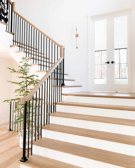 Black Metal Spindles, Stair Riser Ideas, Stair Landing Ideas, Wrought Iron Stair Spindles, Double French Door, Wide Staircase, Stair Landing Decor, Painted Stair Risers, White Stair Risers