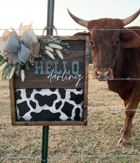 This western style door hanger would look great on anyone's home! It would also make a great gift for someone.  Sign is 17.5 x 15 x 1.5 Framed with dark walnut stain Half stained and half cow print Western style tacks added for decor Letters are cutout using a laser. Rope for a hanger on the back Ribbon and greenery may be a little different due to availability. I will do my best to choose something close. Your sign will ship out in 2-3 weeks.  Please feel free to message me regarding your order! Hello Darling Sign, Cow Print Porch Sign, Western Door Hangers, Cow Print Door Hanger, Cow Print Door, Cow Signs, Western Door, Cow Door Hanger, Snowman Ideas