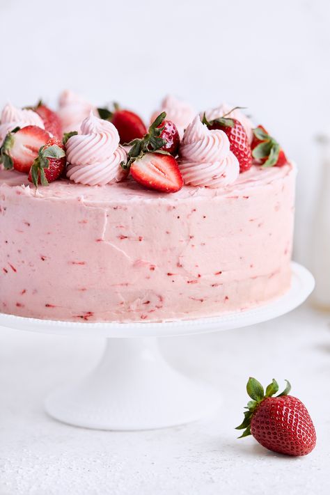 Spongey, buttery vanilla cake is sandwiched with fresh strawberries and coated in a strawberry frosting. Recipe by Tutti Dolci. #californiastrawberries #springcake #dessertrecipes #cakerecipe #strawberrycake #layercake #vanillacake #bakingathome #vanillastrawberrycake #springrecipes #strawberrydessert Pretty Strawberry Cake Birthday, Tiered Strawberry Cake, Strawberries Birthday Cake, Strawberry Heart Cake Aesthetic, Vanilla Cake Strawberry Frosting, Vanilla Strawberry Cake Design, Strawberry Cake With Frosting, Cake That Looks Like A Strawberry, Strawberry Frosted Cake