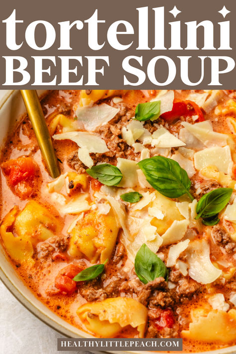 A pinterest pin for creamy beef tortellini soup. A photo of a bowl with soup garnished with basil Tortellini Soup Crockpot Ground Beef, Tortellini Hamburger Soup, Cheeseburger Tortellini Soup, Creamy Beef Tortellini Soup, Creamy Meatball Tortellini Soup, Healthy Tortellini Soup Recipes, Tortellini Soup With Ground Beef, Soup With Mini Meatballs, Tortini Soup