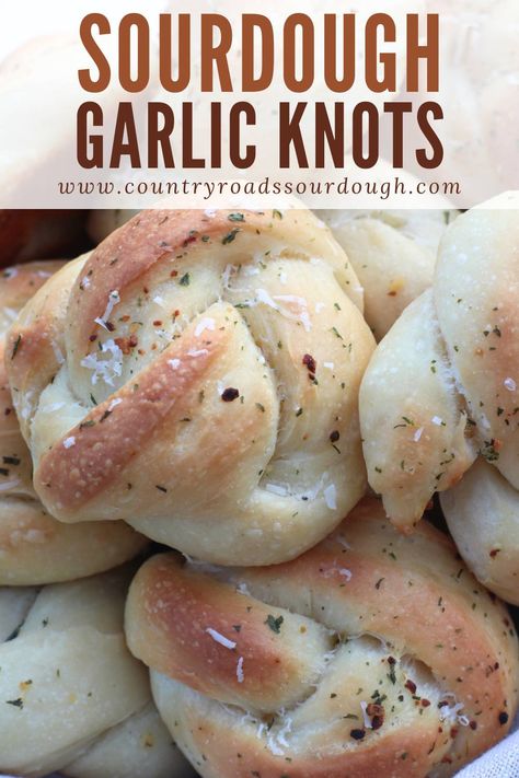 These Fluffy Buttery Sourdough Garlic Knots are the perfect addition to pizza night, game day, or any holiday gathering! Made with an active sourdough starter and no yeast, they’re naturally leavened and ready in just one day. Each knot is brushed with garlic butter, sprinkled with parmesan cheese, and baked to perfection. Whether you're serving them as an appetizer or side, these cheesy, homemade garlic knots will impress everyone at the table! Sourdough Garlic Knots Easy, Garlic Sourdough Bread Recipe, Active Sourdough Starter Recipes Quick, Sour Dough Rolls Using Starter, Sourdough Party Food, Sourdough Garlic Rolls, Sourdough Garlic Knots, Garlic Sourdough Bread, Sourdough Discard Garlic Knots