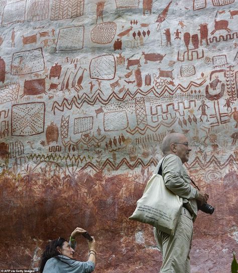 The eight-mile wall of prehistoric rock art featuring animals and human and created up to 12,500 years ago has been discovered by a team of team of archaeologists Prehistoric Painting, Petroglyphs Art, Paleolithic Art, Prehistoric Cave Paintings, Lakshmi Statue, Stone Age Art, Pictures Of Rocks, The Sistine Chapel, Cave Drawings