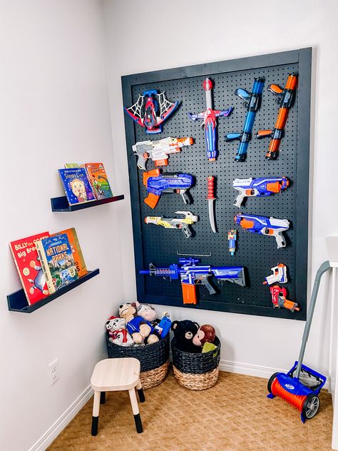 Little Boys Room Wall Shelves, Hero Up Costume Wall, Nerf Fun Wall, Fortnight Bedroom Ideas For Boys, Nurf Wall, Nerf Wall Boy Rooms, Pegboard Nerf Wall, Nerf Pegboard Wall, Nerf Room Ideas Boys